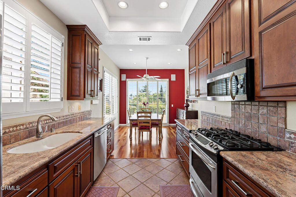 Kitchen opens to breakfast room with plantation shutters