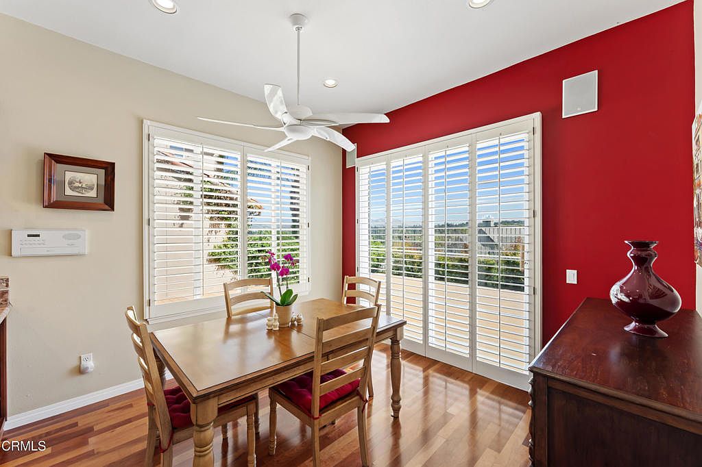 Dining area with hardwood floors, fresh accent wall, and mountain-facing windows