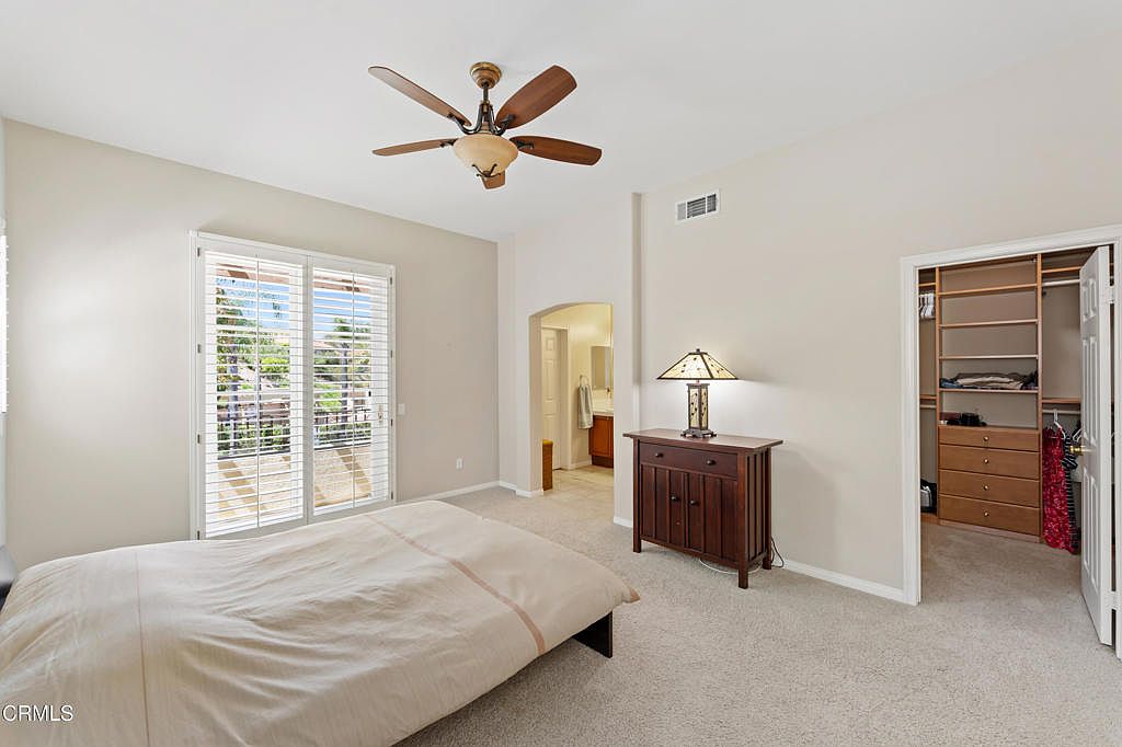 Primary bedroom retreat with high ceilings and plantation shutters